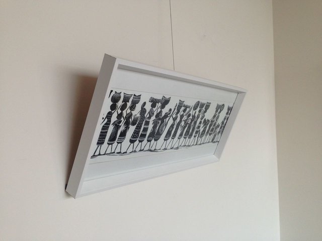 picture leaning forward on picture hanging system